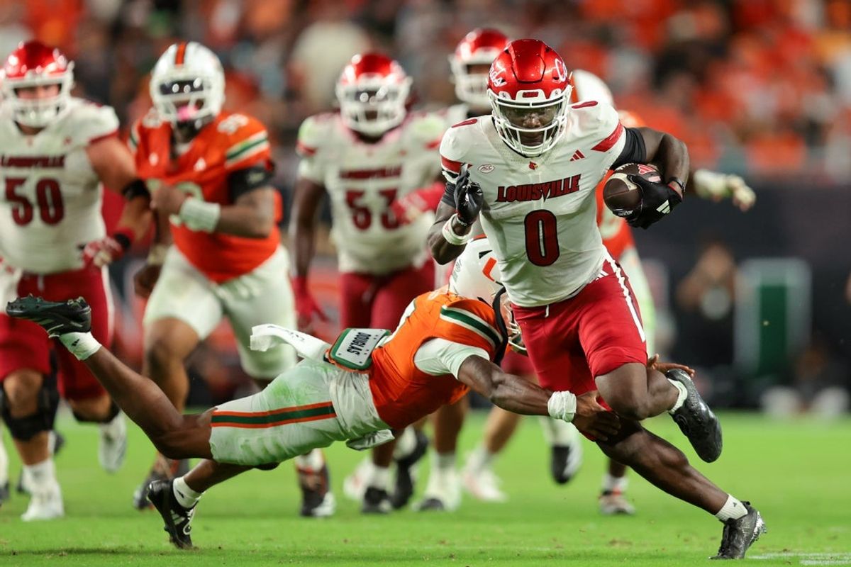 Oct 17, 2025; Miami Gardens, Florida, USA; Louisville Cardinals wide receiver Chris Bell (0) carries the football for a touchdown against the Miami Hurricanes during the fourth quarter at Hard Rock Stadium. Mandatory Credit: Sam Navarro-Imagn Images