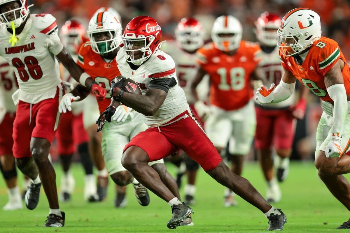 Oct 17, 2025; Miami Gardens, Florida, USA; Louisville Cardinals wide receiver Chris Bell (0) carries the football for a touchdown against the Miami Hurricanes during the fourth quarter at Hard Rock Stadium. Mandatory Credit: Sam Navarro-Imagn Images