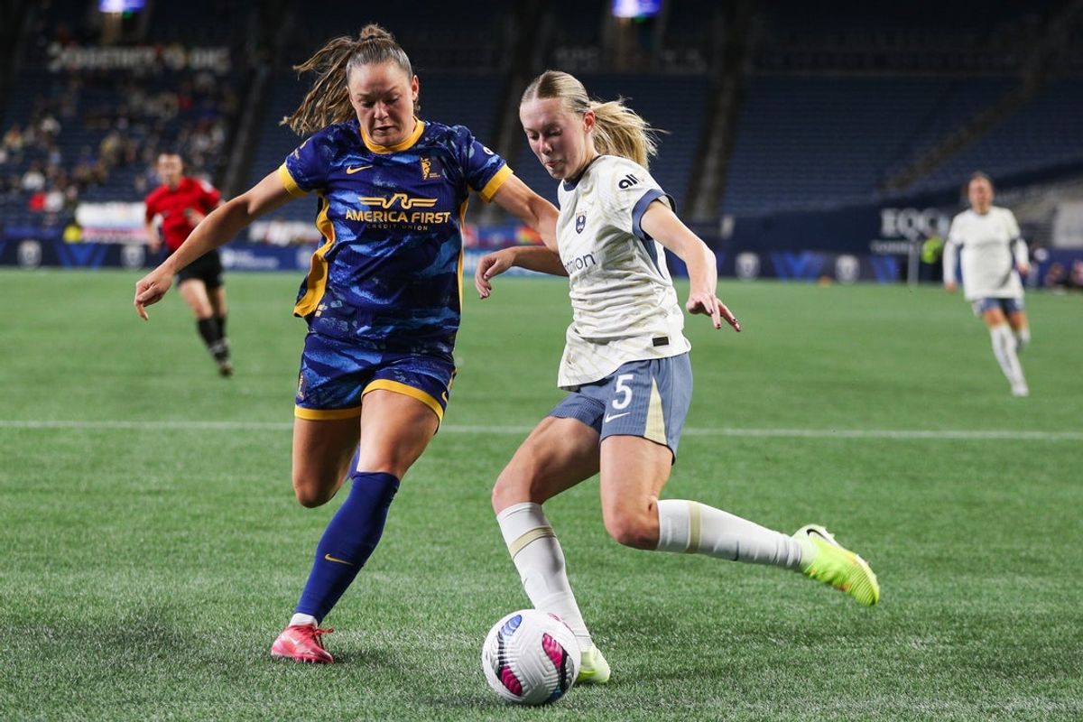 Oct 17, 2025; Seattle, Washington, USA; Seattle Reign FC forward Maddie Dahlien (5) crosses the ball during the first half against the Utah Royals FC at Lumen Field. Mandatory Credit: Kevin Ng-Imagn Images