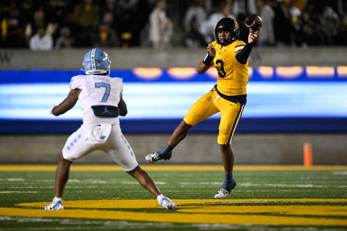Oct 17, 2025; Berkeley, California, USA; California Golden Bears quarterback Jaron-Keawe Sagapolutele (3) looks for a pass while under pressure from North Carolina Tar Heels linebacker Khmori House (7) in the second quarter at California Memorial Stadium. Mandatory Credit: Eakin Howard-Imagn Images