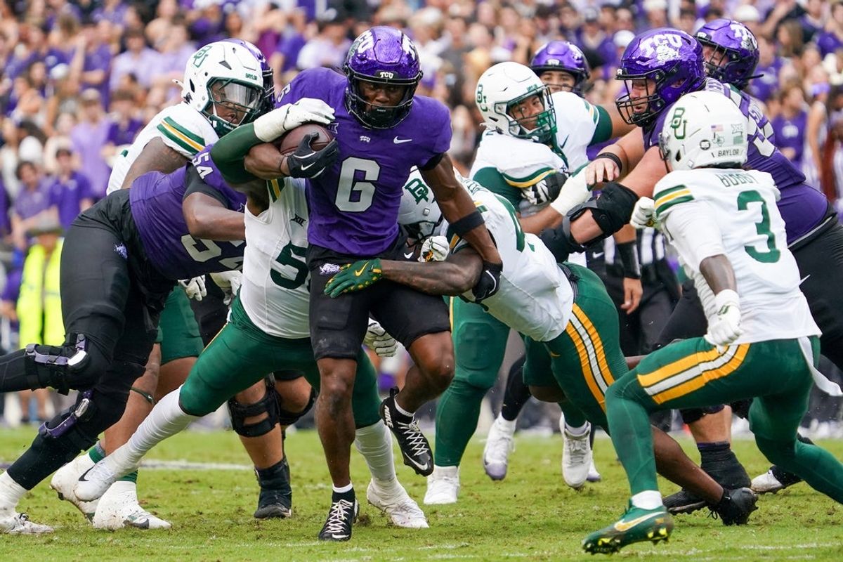 Oct 18, 2025; Fort Worth, Texas, USA; TCU Horned Frogs running back Trent Battle (6) is tackled by Baylor Bears linebacker Matthew Fobbs-White (50) and linebacker Kyland Reed (45) during the first half of a game at Amon G. Carter Stadium. Mandatory Credit: Raymond Carlin III-Imagn Images
