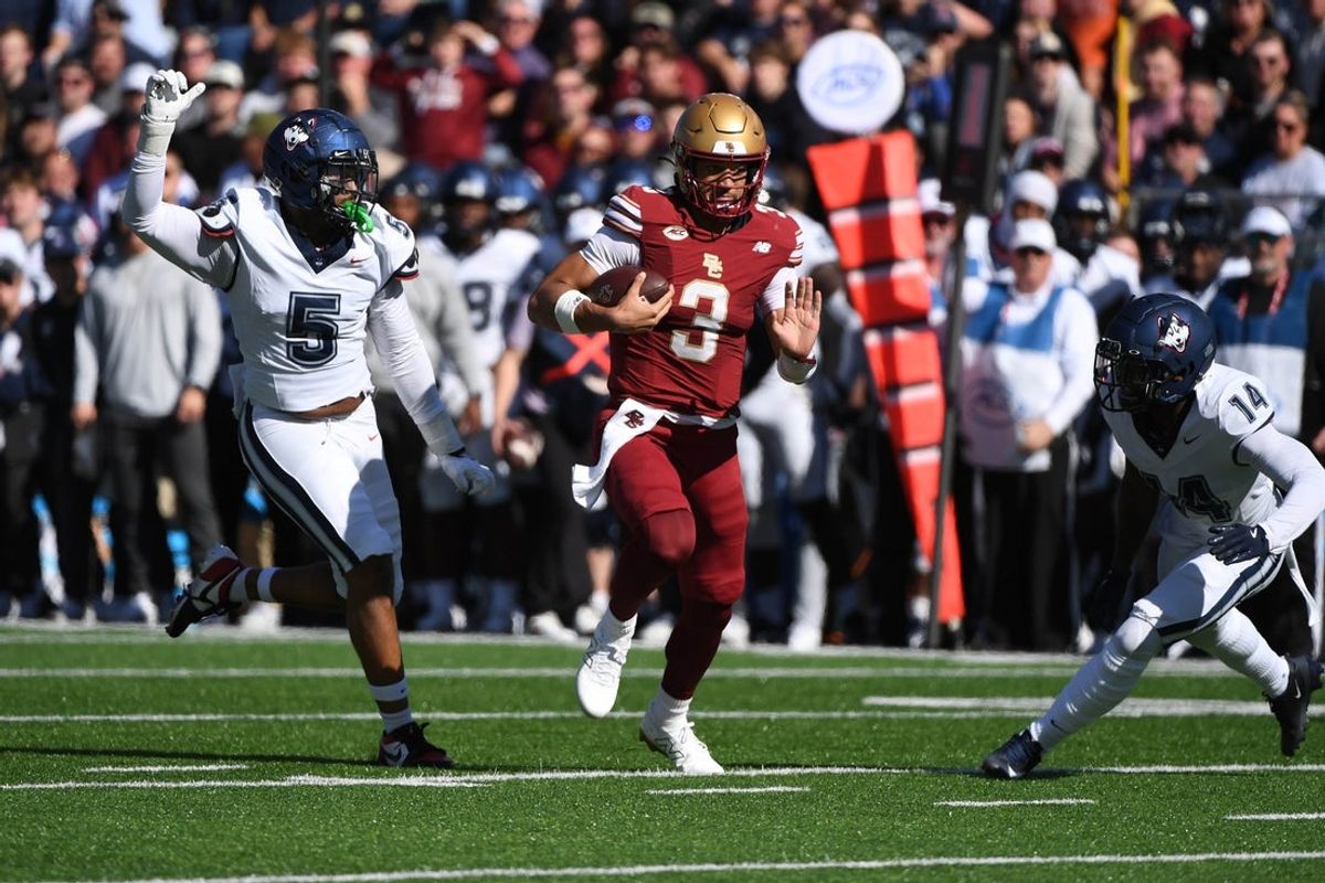 Oct 18, 2025; Chestnut Hill, Massachusetts, USA;  Boston College Eagles quarterback Grayson James (3) runs with the ball while UConn Huskies linebacker Aaron Key (5) defends during the first half at Alumni Stadium. Mandatory Credit: Bob DeChiara-Imagn Images
