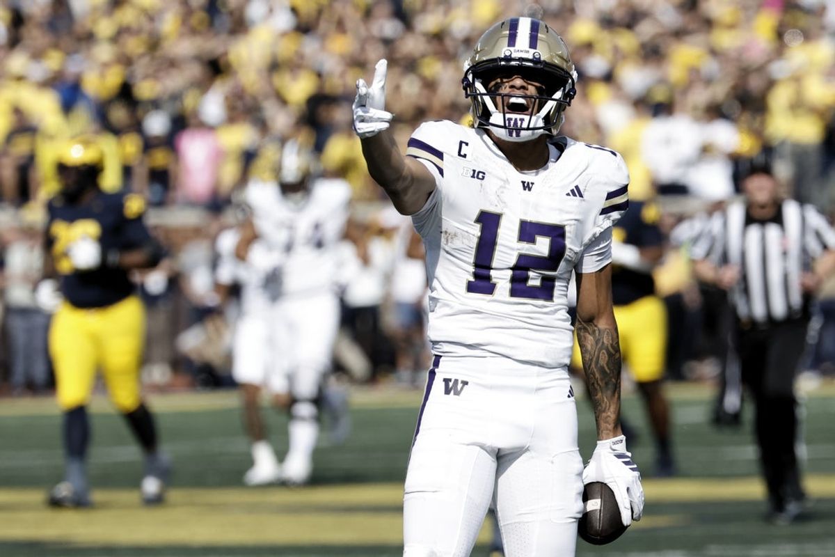 Oct 18, 2025; Ann Arbor, Michigan, USA;  Washington Huskies wide receiver Denzel Boston (12) celebrates after he makes a reception in the first half against the Michigan Wolverines at Michigan Stadium. Mandatory Credit: Rick Osentoski-Imagn Images