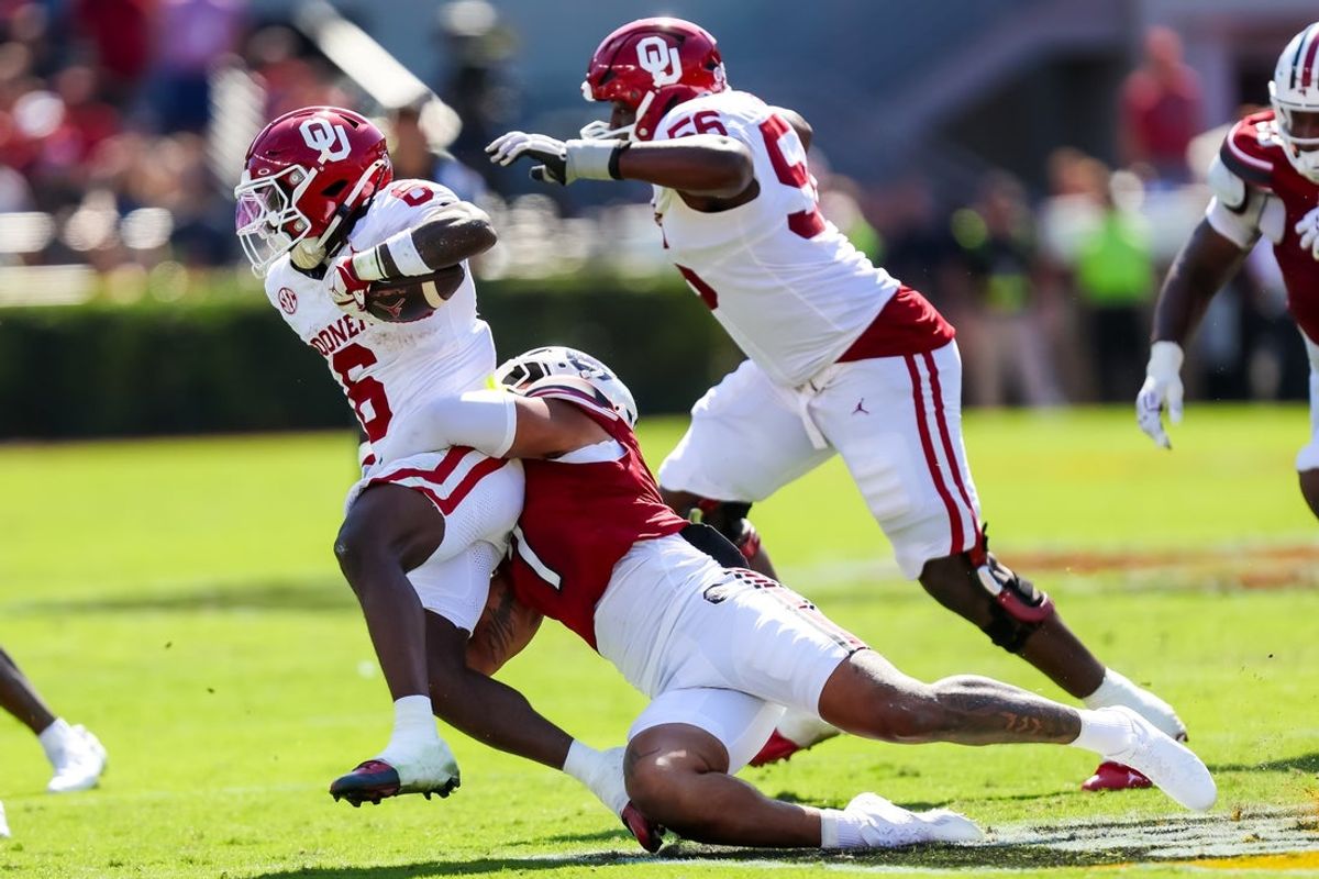 Oct 18, 2025; Columbia, South Carolina, USA; Oklahoma Sooners running back Tory Blaylock (6) is brought down by South Carolina Gamecocks defensive back Dq Smith (1) in the first quarter at Williams-Brice Stadium. Mandatory Credit: Jeff Blake-Imagn Images