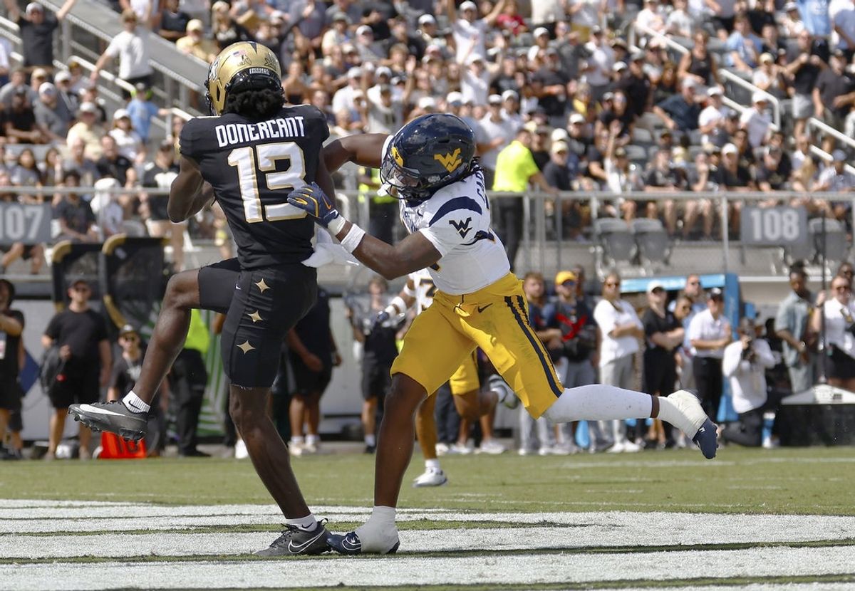 Oct 18, 2025; Orlando, Florida, USA;  Central Florida Knights wide receiver Chris Domercant (13) reels in his second touchdown pass of the first half against the West Virginia Mountaineers at Acrisure Bounce House. Mandatory Credit: Russell Lansford-Imagn Images