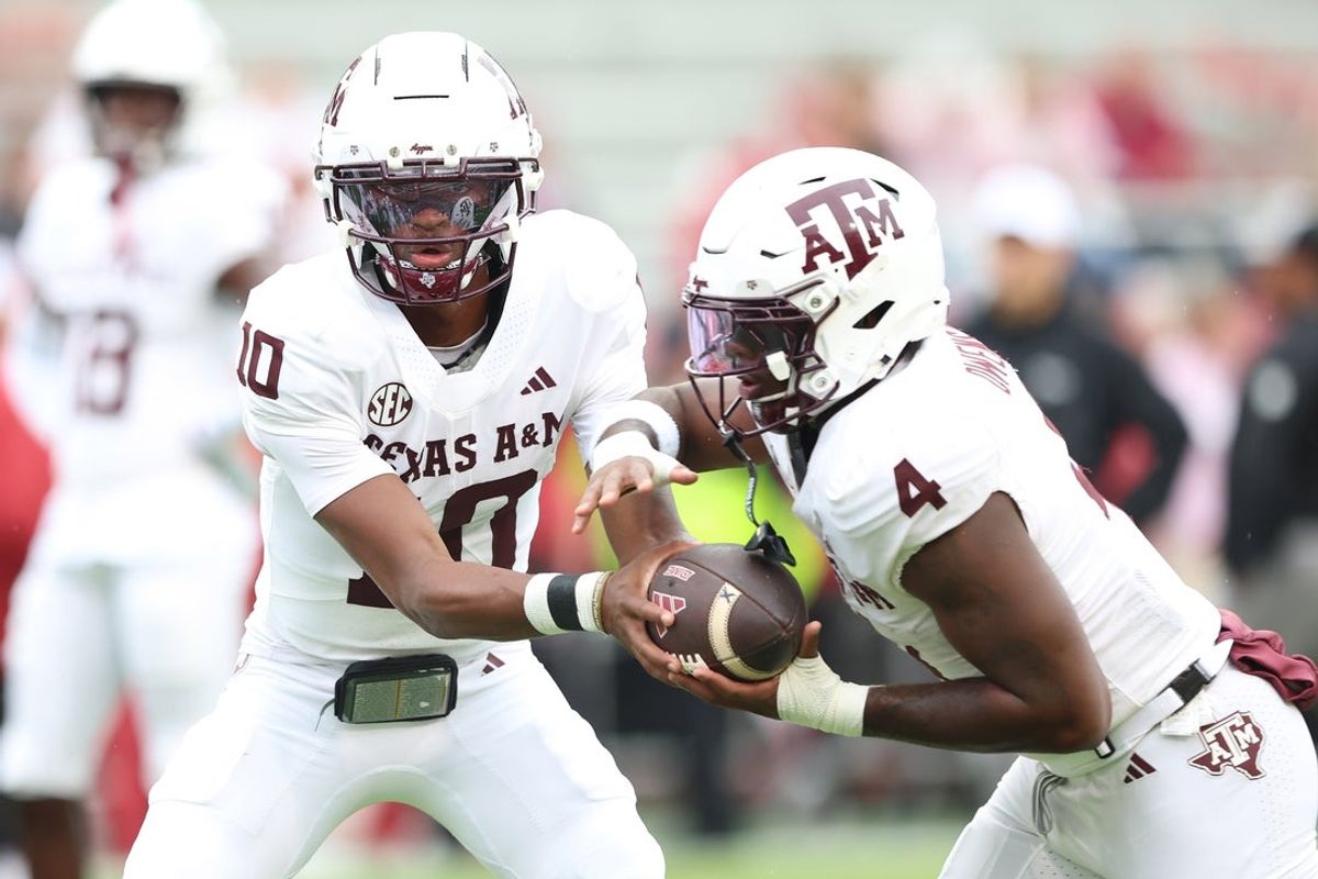 Oct 18, 2025; Fayetteville, Arkansas, USA; Texas A&M Aggies quarterback Marcel Reed (10) and running back Rueben Owens II (4) warm up prior to the game against the Arkansas Razorbacks at Donald W. Reynolds Razorback Stadium. Mandatory Credit: Nelson Chenault-Imagn Images