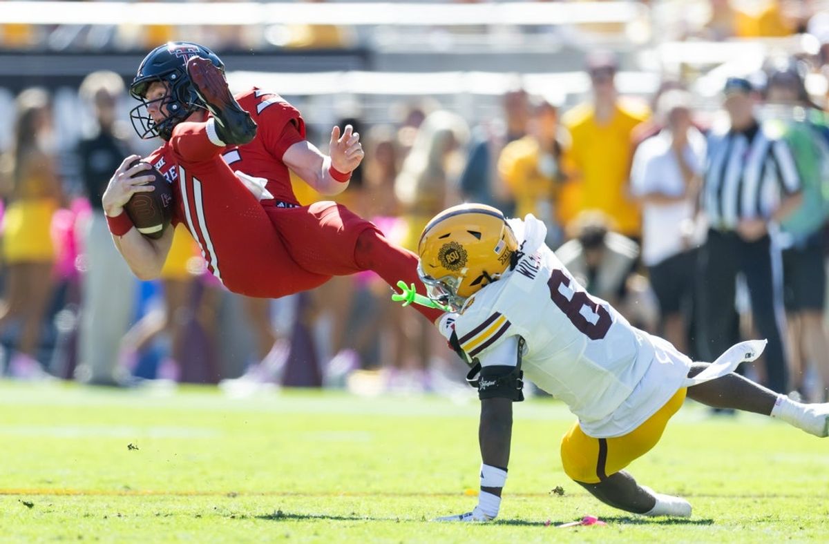 Oct 18, 2025; Tempe, Arizona, USA; Texas Tech Red Raiders quarterback Will Hammond (15) is upended by Arizona State Sun Devils safety Adrian Wilson (6) in the first half at Mountain America Stadium. Mandatory Credit: Mark J. Rebilas-Imagn Images