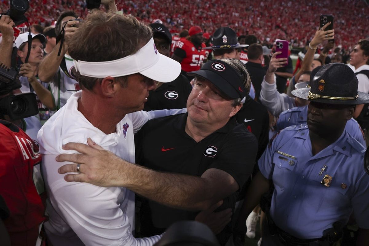 Oct 18, 2025; Athens, Georgia, USA;  Georgia Bulldogs head coach Kirby Smart and Mississippi Rebels head coach Lane Kiffin meet on the field after the game at Sanford Stadium. Mandatory Credit: Brett Davis-Imagn Images