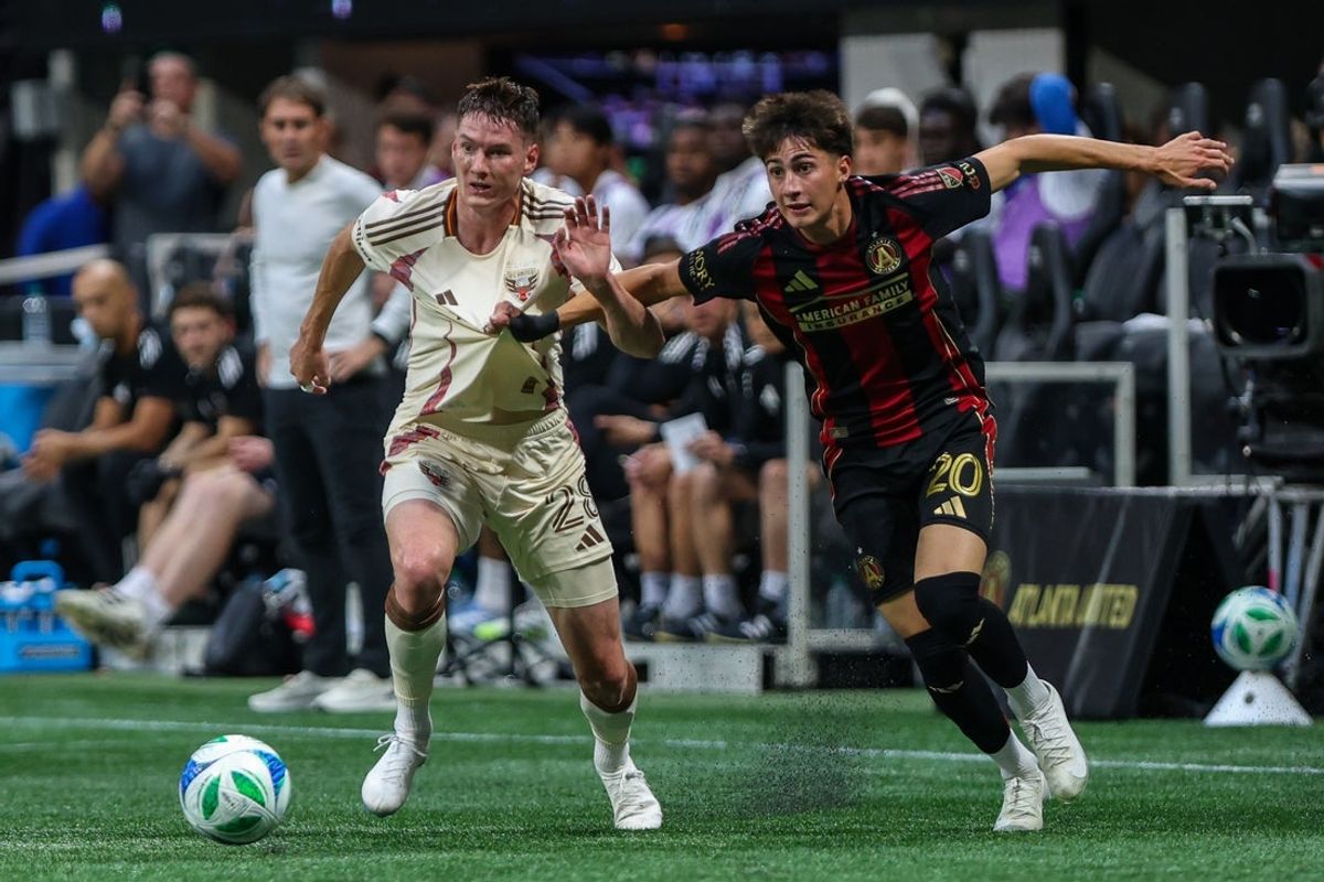 Oct 18, 2025; Atlanta, Georgia, USA; Atlanta United midfielder Luke Brennan (20) runs for the ball against D.C. United defender David Schnegg (28) during the first half at Mercedes-Benz Stadium. Mandatory Credit: Jordan Godfree-Imagn Images
