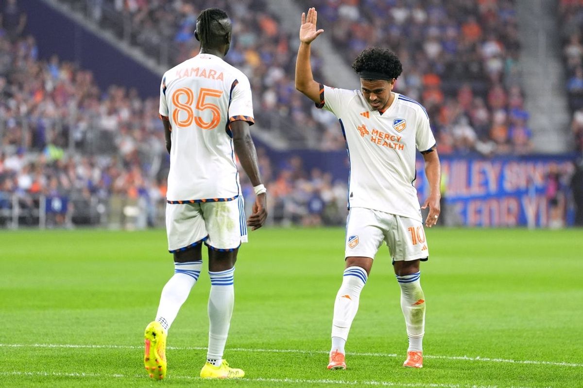 Oct 18, 2025; Cincinnati, Ohio, USA; FC Cincinnati midfielder Evander (10) high fives forward Kei Kamara (85) during the first half of a match against CF Montreal at TQL Stadium. Mandatory Credit: Kareem Elgazzar-Imagn Images