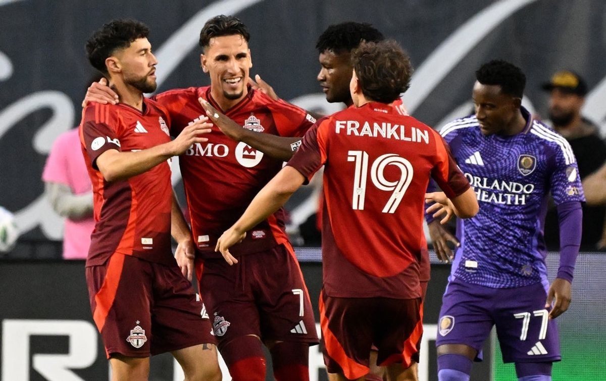 Oct 18, 2025; Toronto, Ontario, CAN;  Toronto FC midfielder Jonathan Osorio (21, left) celebrates with team mates after scoring a goal against Orlando City in the first half at BMO Field. Mandatory Credit: Dan Hamilton-Imagn Images