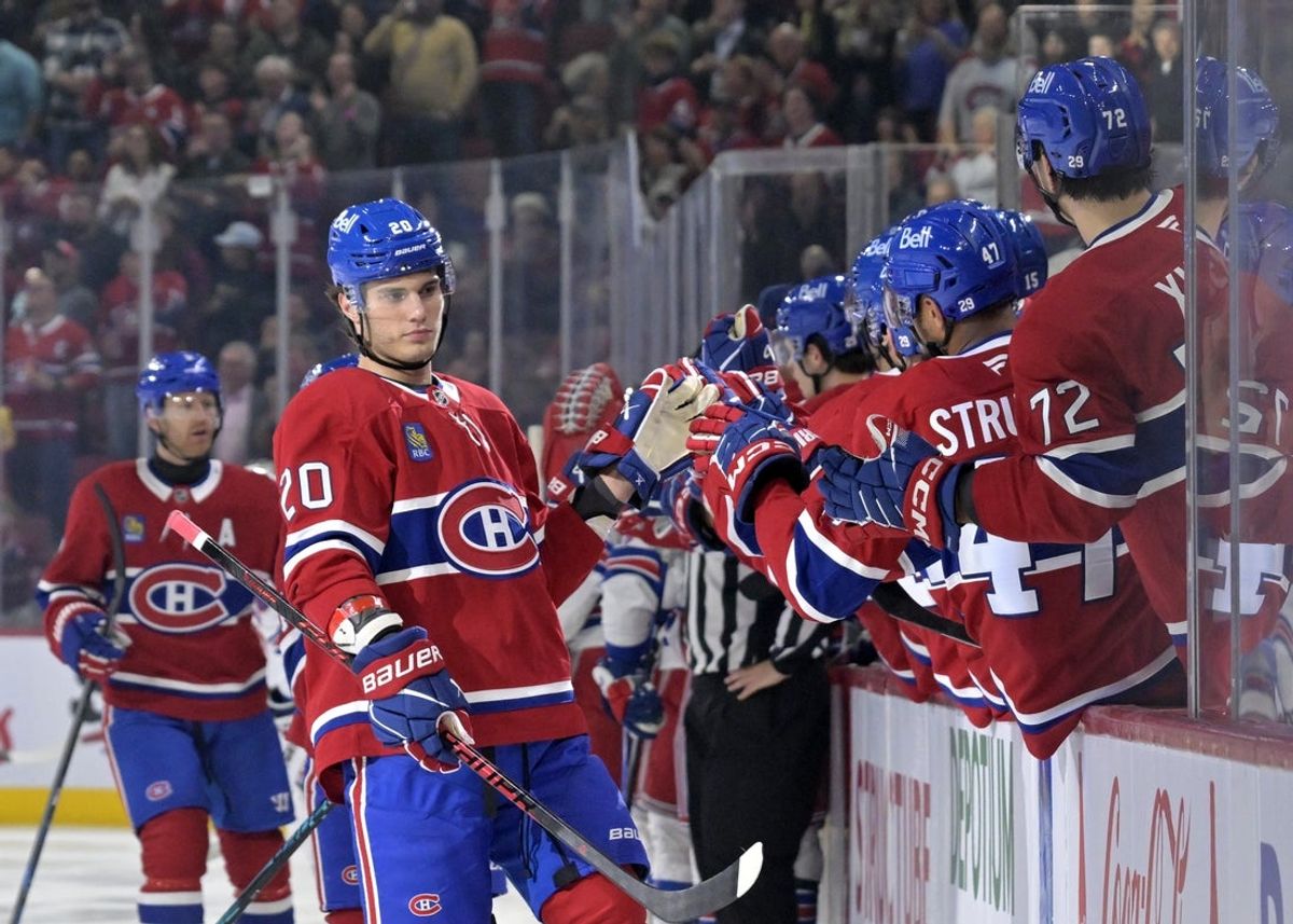 Oct 18, 2025; Montreal, Quebec, CAN; Montreal Canadiens forward Juraj Slafkovsky (20) celebrates with teammates after scoring a goal against the New York Rangers during the first period at the Bell Centre. Mandatory Credit: Eric Bolte-Imagn Images