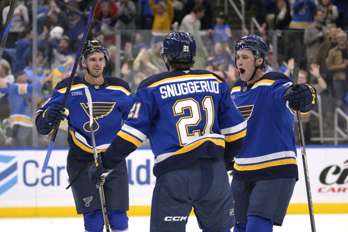 Oct 18, 2025; St. Louis, Missouri, USA; St. Louis Blues right wing Jimmy Snuggerud (21) is congratulated by left wing Pavel Buchnevich (89) and defenseman Tyler Tucker (75) after scoring against the Dallas Stars during the second period at Enterprise Center. Mandatory Credit: Jeff Le-Imagn Images