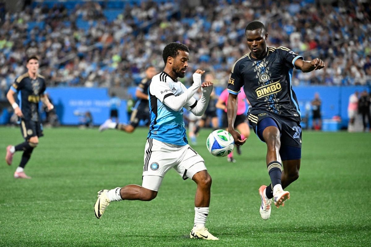 Oct 18, 2025; Charlotte, North Carolina, USA; Charlotte FC defender Nathan Byrne (14) and Philadelphia Union defender Olwethu Makhanya (29) fight for the ball in the second half at Bank of America Stadium. Mandatory Credit: Bob Donnan-Imagn Images