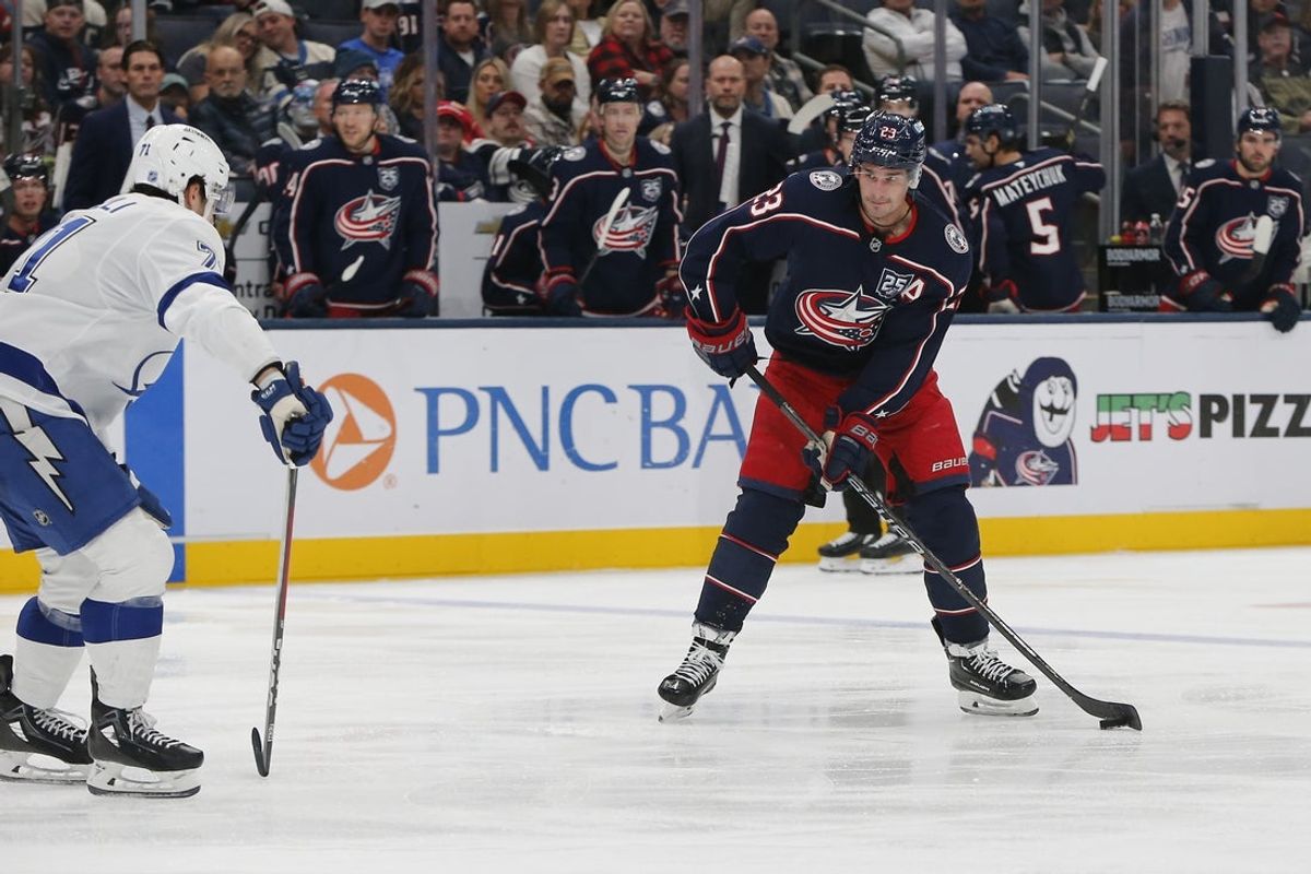 Oct 18, 2025; Columbus, Ohio, USA; Columbus Blue Jackets center Sean Monahan (23) looks to pass defended by Tampa Bay Lightning center Anthony Cirelli (71) during the second period at Nationwide Arena. Mandatory Credit: Russell LaBounty-Imagn Images