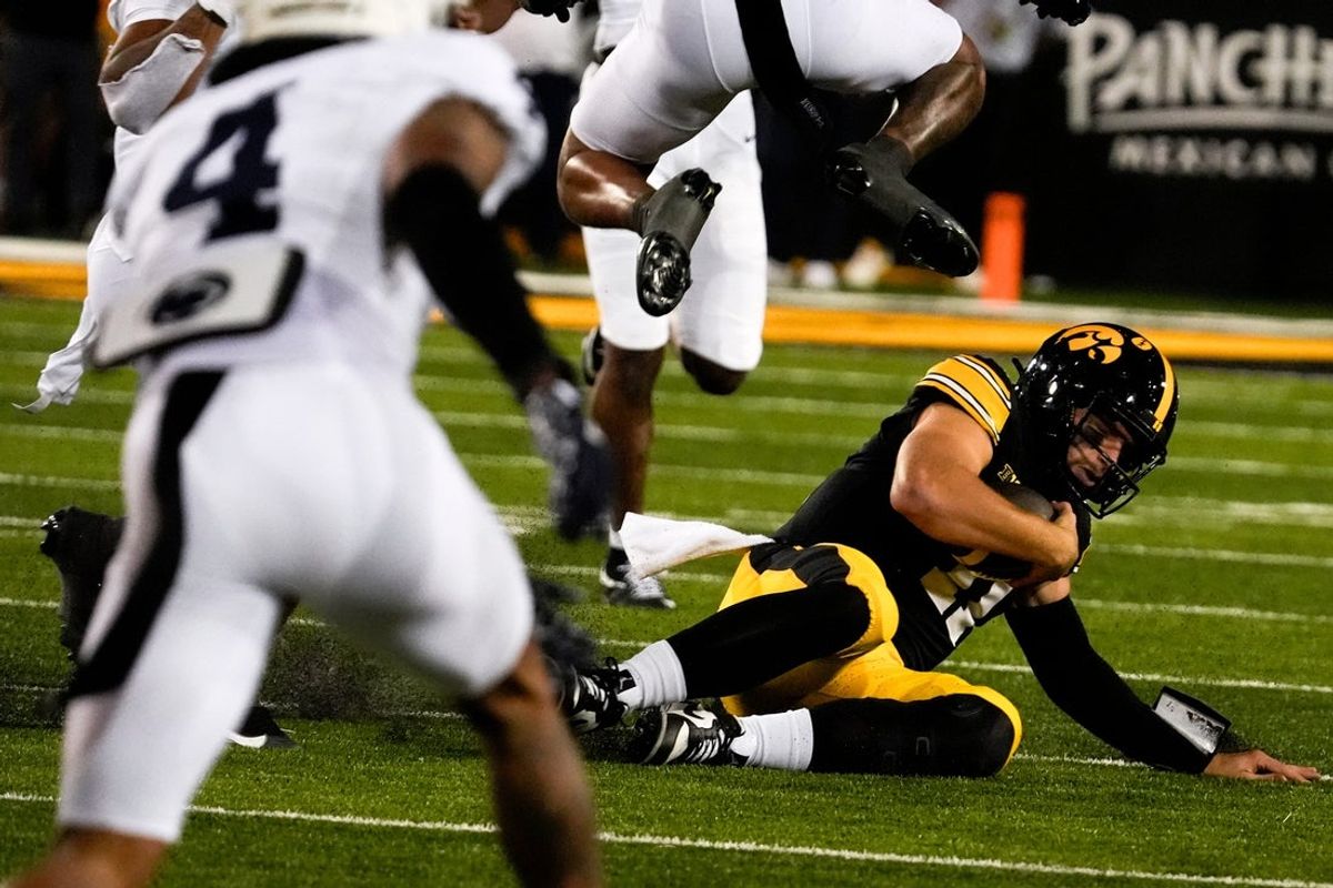 Iowa Hawkeyes quarterback Mark Gronowski (11) slides during a college football game against the Penn State Nittany Lions Oct. 18, 2025 at Kinnick Stadium in Iowa City, Iowa.