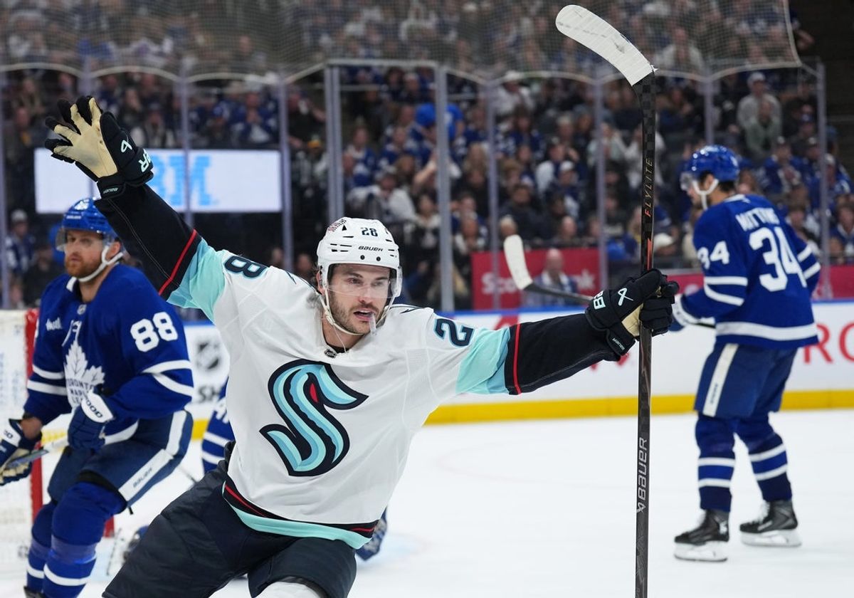 Oct 18, 2025; Toronto, Ontario, CAN; Seattle Kraken defenseman Joshua Mahura (28) celebrates after scoring the winning goal against the Toronto Maple Leafs during the overtime period at Scotiabank Arena. Mandatory Credit: Nick Turchiaro-Imagn Images