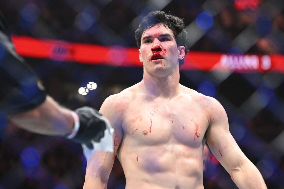 Oct 18, 2025; Vancouver, BC, CANADA; Mike Malott (blue gloves) reacts during the fight against Kevin Holland (red gloves) during UFC Fight Night at Rogers Arena. Mandatory Credit: Simon Fearn-Imagn Images