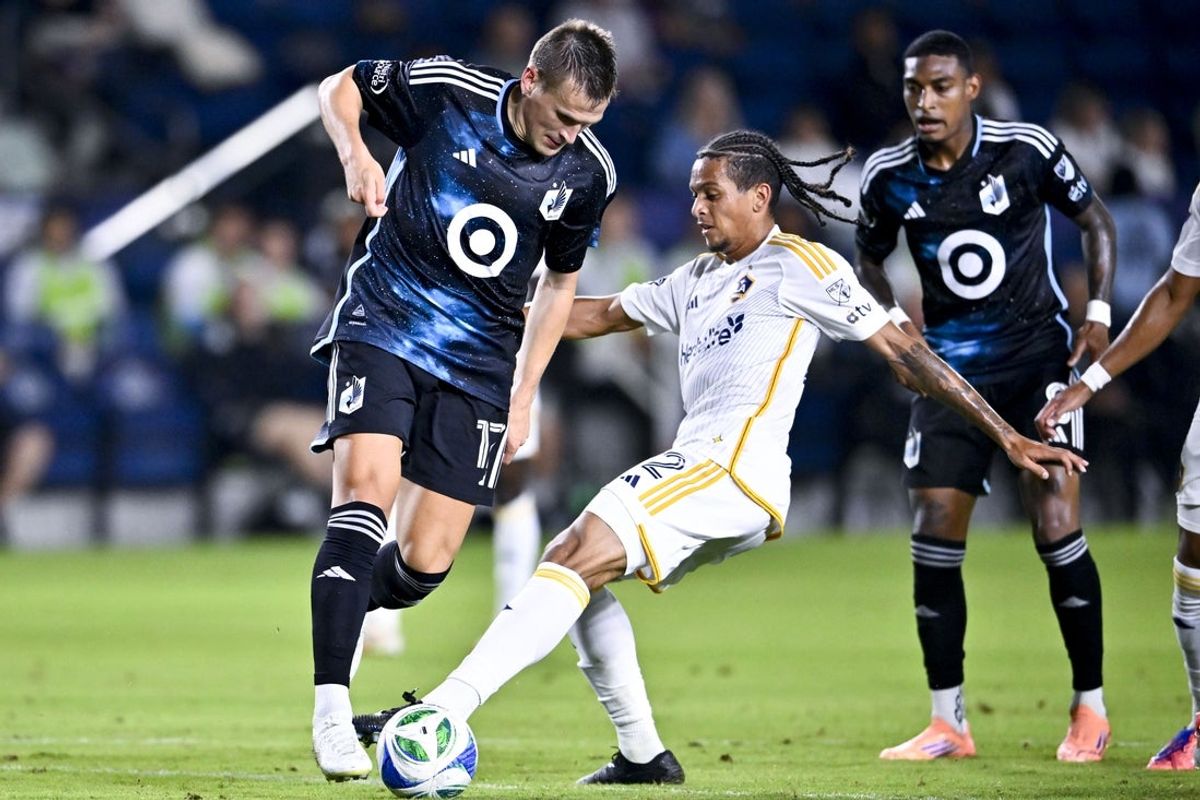 Oct 18, 2025; Carson, California, USA; Minnesota United FC midfielder Robin Lod (17) moves the ball while LA Galaxy midfielder Elijah Wynder (22) defends during the first half at Dignity Health Sports Park. Mandatory Credit: Kelvin Kuo-Imagn Images