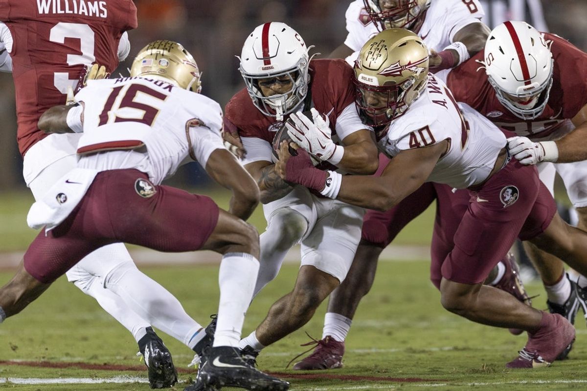 Oct 18, 2025; Stanford, California, USA;  Stanford Cardinal running back Cole Tabb (33) runs with the football during the first quarter against Florida State Seminoles defensive back Shamar Arnoux (15) and Florida State Seminoles defensive lineman Amaree Williams (40) at Stanford Stadium. Mandatory Credit: Stan Szeto-Imagn Images