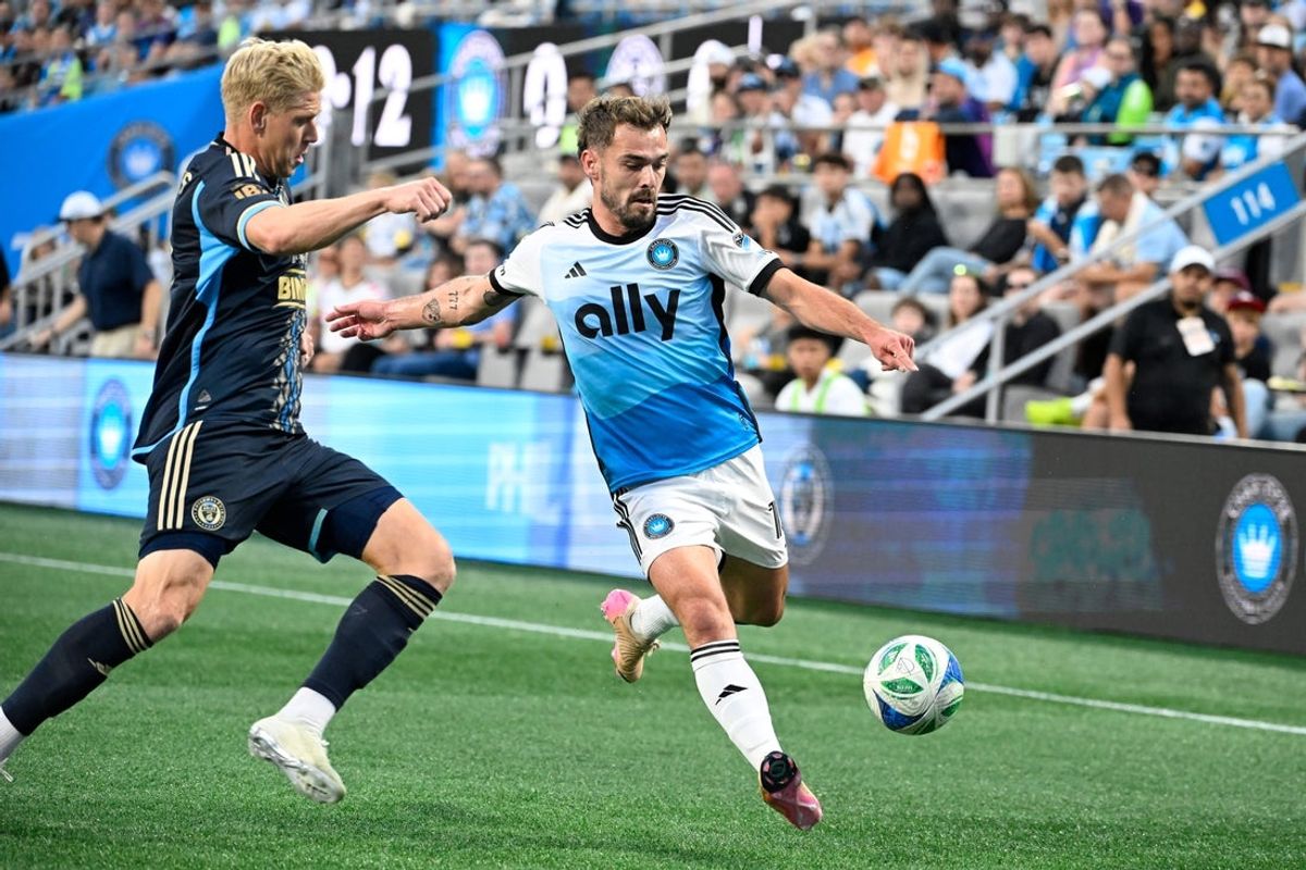 Oct 18, 2025; Charlotte, North Carolina, USA; Charlotte FC defender Harry Toffolo (15) with the ball as Philadelphia Union defender Jakob Glesnes (5) defends in the first half at Bank of America Stadium. Mandatory Credit: Bob Donnan-Imagn Images