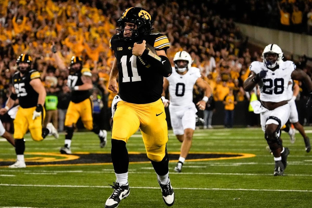 Iowa Hawkeyes quarterback Mark Gronowski (11) carries the ball down field during a college football game against the Penn State Nittany Lions Oct. 18, 2025 at Kinnick Stadium in Iowa City, Iowa.