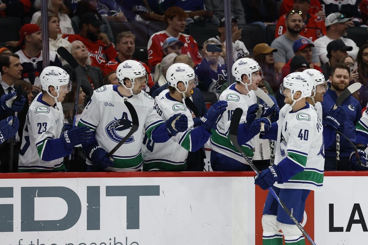 Oct 19, 2025; Washington, District of Columbia, USA; Vancouver Canucks center Elias Pettersson (40) celebrates with teammates after scoring a goal against the Washington Capitals during the first period at Capital One Arena. Mandatory Credit: Geoff Burke-Imagn Images