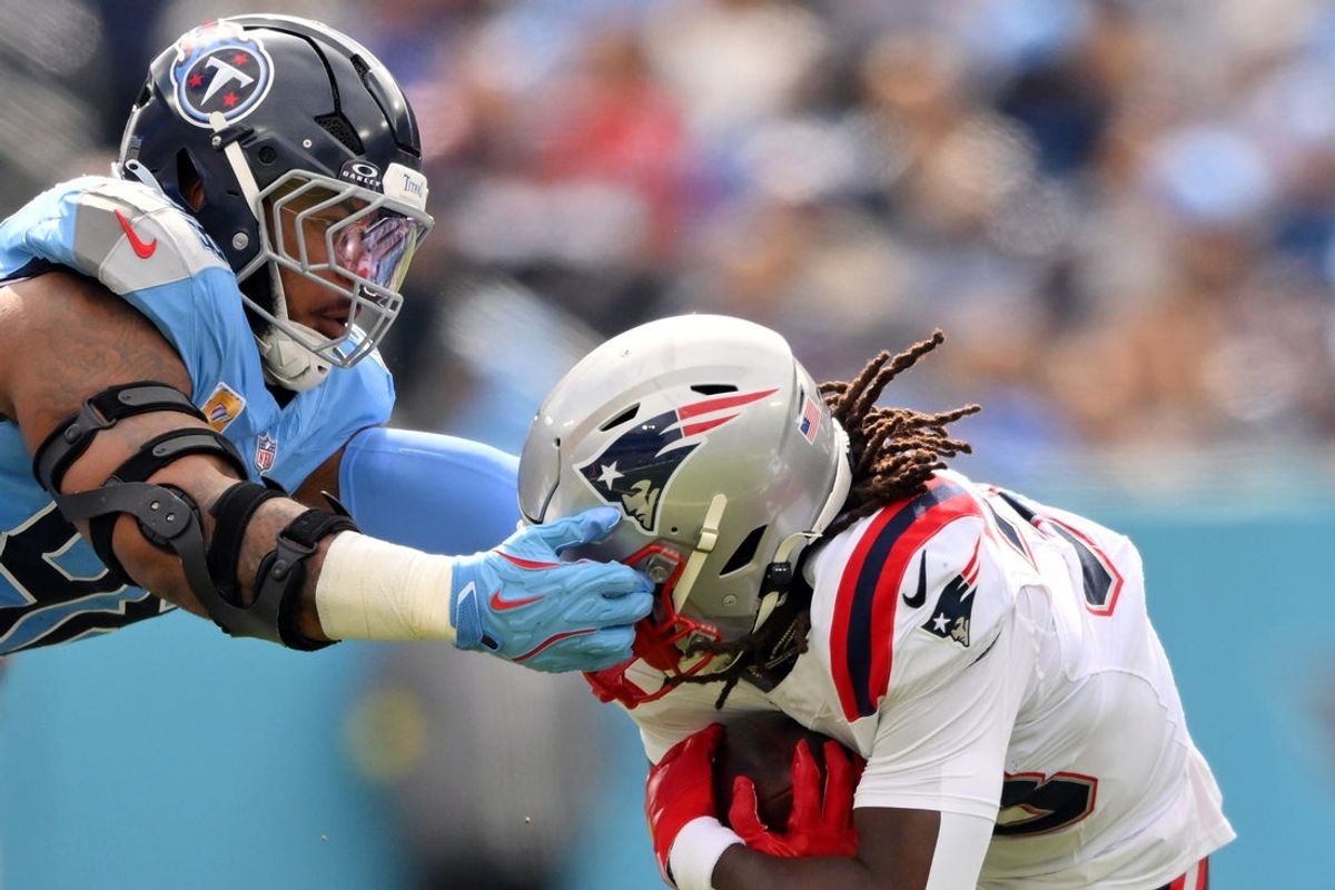 Oct 19, 2025; Nashville, Tennessee, USA; Tennessee Titans defensive tackle Jeffery Simmons (98) reaches for New England Patriots running back Rhamondre Stevenson (38) during the first half at Nissan Stadium. Mandatory Credit: Steve Roberts-Imagn Images