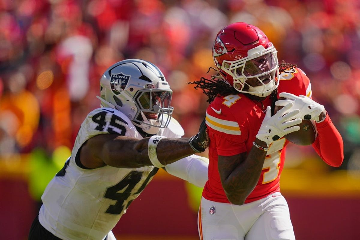Oct 19, 2025; Kansas City, Missouri, USA; Kansas City Chiefs wide receiver Rashee Rice (4) makes a reception defended by Las Vegas Raiders linebacker Devin White (45) during the second quarter of the game at GEHA Field at Arrowhead Stadium. Mandatory Credit: Jay Biggerstaff-Imagn Images