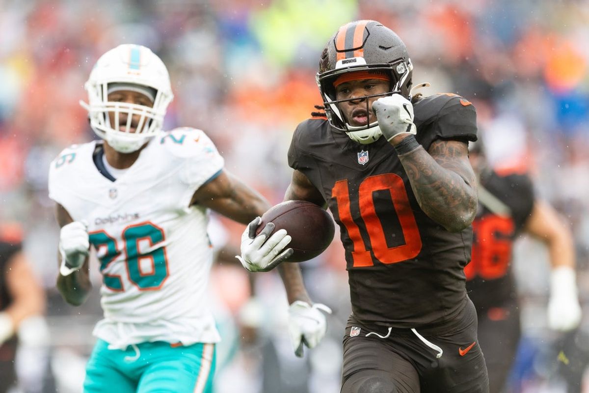 Oct 19, 2025; Cleveland, Ohio, USA; Cleveland Browns running back Quinshon Judkins (10) runs the ball for a touchdown against Miami Dolphins cornerback Rasul Douglas (26) during the second quarter at Huntington Bank Field. Mandatory Credit: Scott Galvin-Imagn Images
