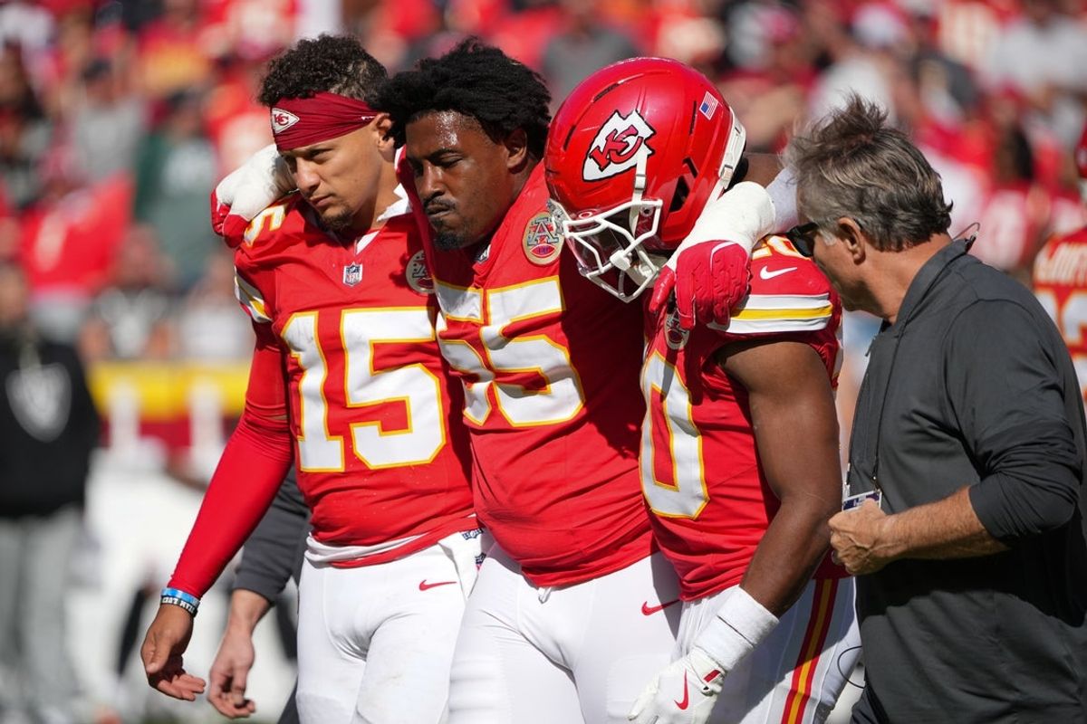 Oct 19, 2025; Kansas City, Missouri, USA; Kansas City Chiefs defensive tackle Omarr Norman-Lott (55) is helped off the field by quarterback Patrick Mahomes (15) and cornerback Nohl Williams (20) after an injury against the Las Vegas Raiders during the third quarter of the game at GEHA Field at Arrowhead Stadium. Mandatory Credit: Denny Medley-Imagn Images