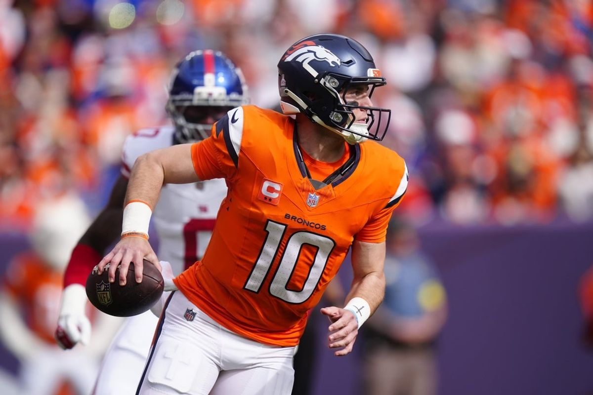 Oct 19, 2025; Denver, Colorado, USA; Denver Broncos quarterback Bo Nix (10) runs the ball during the first half against the New York Giants at Empower Field at Mile High. Mandatory Credit: Ron Chenoy-Imagn Images