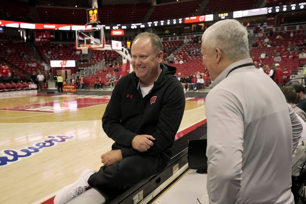 Head coach Greg Gard, left, speaks with broadcaster Matt Lepay before a Wisconsin men’s basketball scrimmage Sunday, October 19, 2025 at the Kohl Center in Madison, Wisconsin.