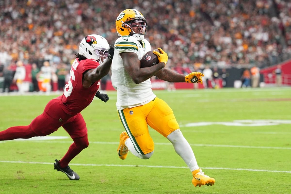 Oct 19, 2025; Glendale, Arizona, USA; Green Bay Packers running back Josh Jacobs (8) runs for a touchdown against the Arizona Cardinals during the second half at State Farm Stadium. Mandatory Credit: Joe Camporeale-Imagn Images