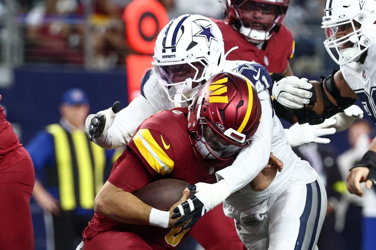 Oct 19, 2025; Arlington, Texas, USA; Dallas Cowboys defensive end Donovan Ezeiruaku (41) sacks Washington Commanders quarterback Marcus Mariota (8) during the fourth quarter of the game at AT&T Stadium. Mandatory Credit: Kevin Jairaj-Imagn Images