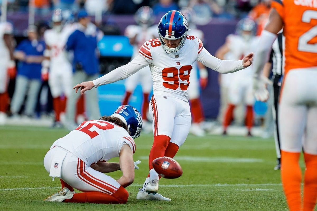 Oct 19, 2025; Denver, Colorado, USA; New York Giants kicker Jude McAtamney (99) misses the point after attempt as punter Jamie Gillan (12) holds in the fourth quarter against the Denver Broncos at Empower Field at Mile High. Mandatory Credit: Isaiah J. Downing-Imagn Images