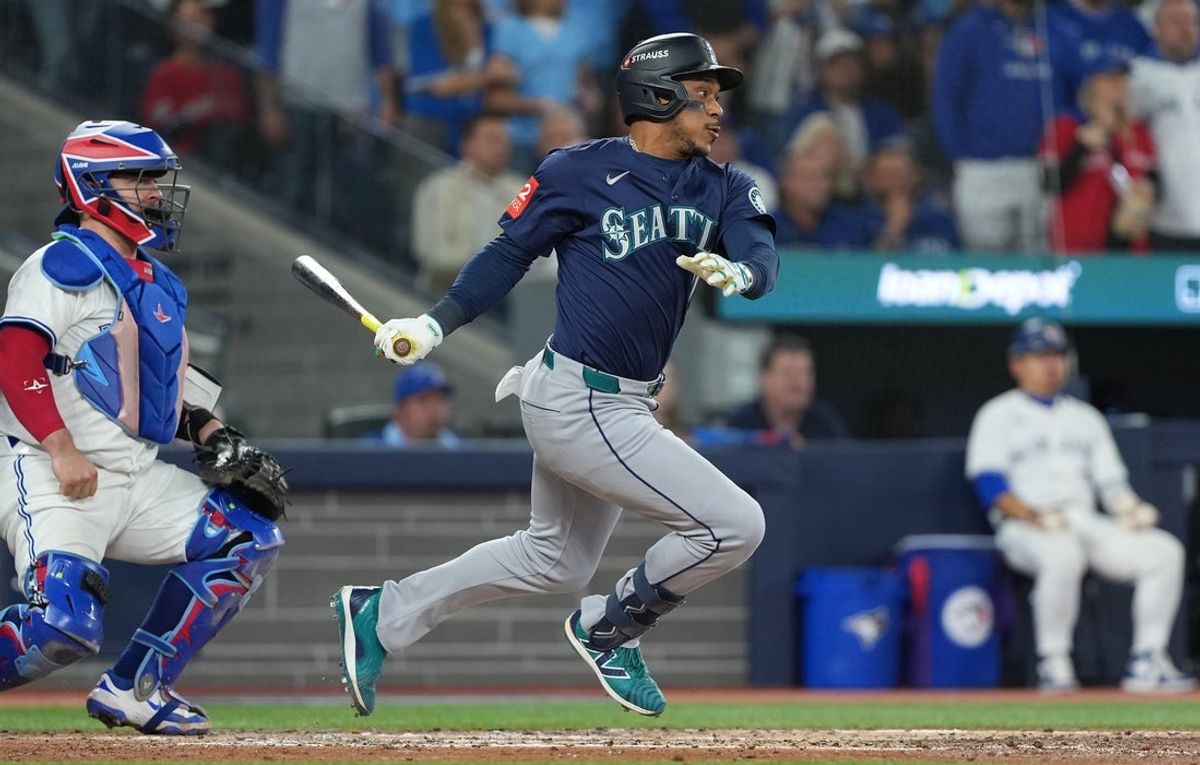 Oct 20, 2025; Toronto, Ontario, CAN; Seattle Mariners second baseman Jorge Polanco (7) singles in the third inning against the Toronto Blue Jays during game seven of the ALCS round for the 2025 MLB playoffs at Rogers Centre. Mandatory Credit: Nick Turchiaro-Imagn Images