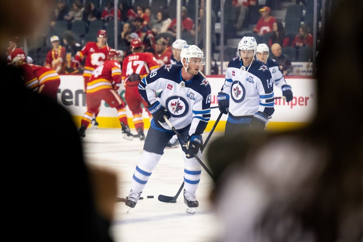Oct 20, 2025; Calgary, Alberta, CAN; Winnipeg Jets center Jonathan Toews (19) warms up before a game against the Calgary Flames at Scotiabank Saddledome. Mandatory Credit: Brett Holmes-Imagn Images