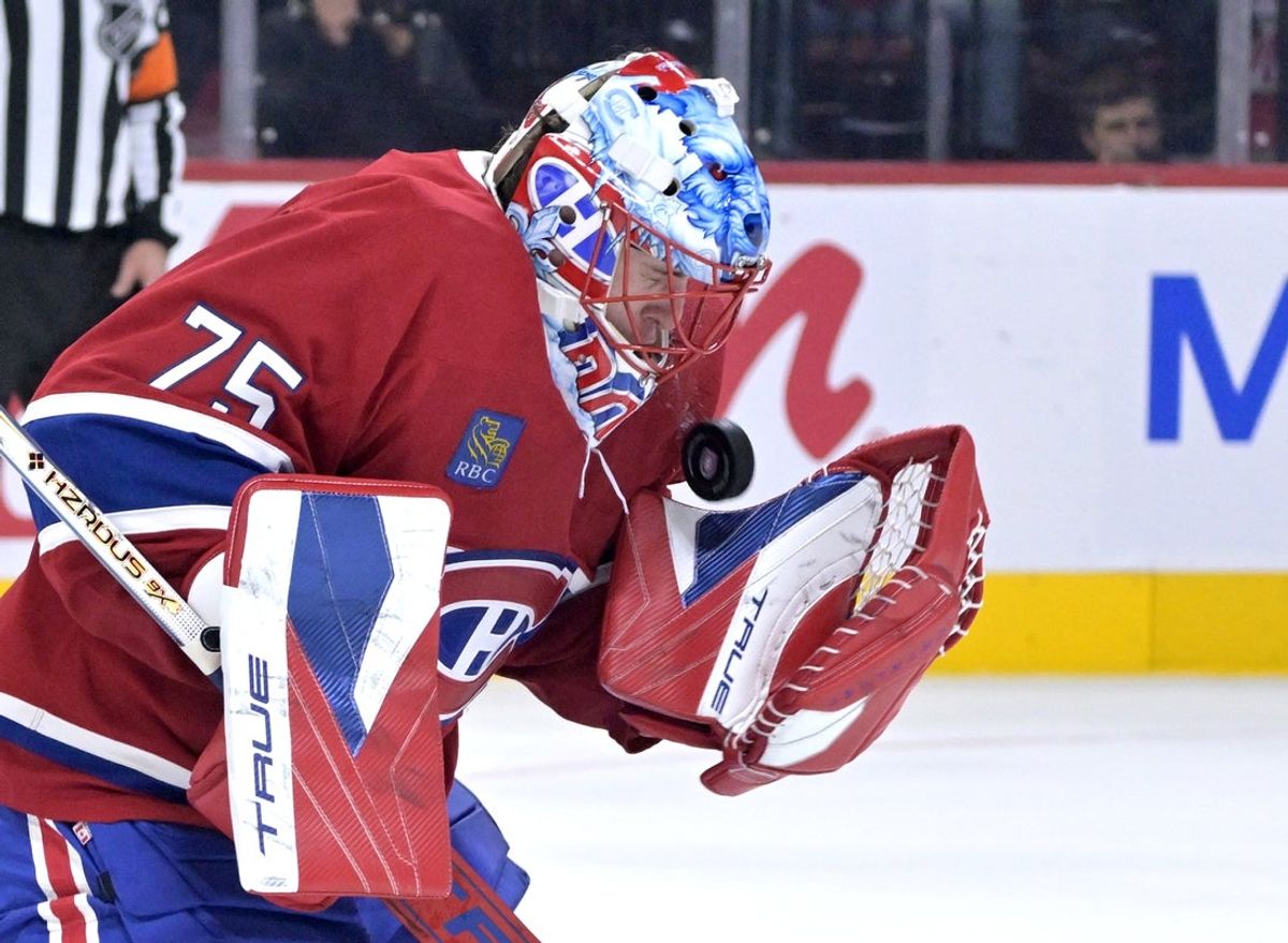 Oct 20, 2025; Montreal, Quebec, CAN; Montreal Canadiens goalie Jakub Dobes (75) makes a save against the Buffalo Sabres during the second period at the Bell Centre. Mandatory Credit: Eric Bolte-Imagn Images