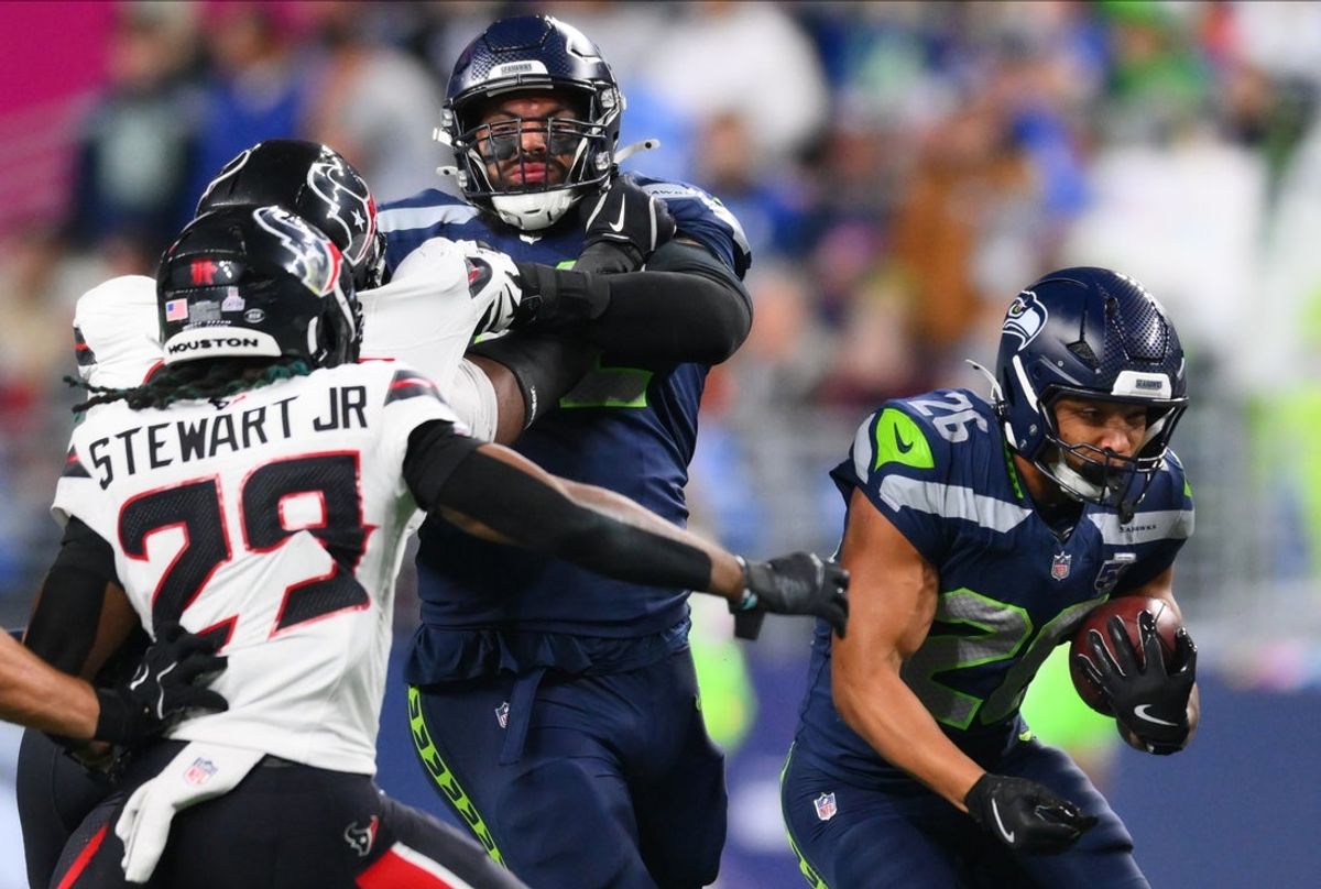 Oct 20, 2025; Seattle, Washington, USA; Seattle Seahawks running back Zach Charbonnet (26) runs the ball during the first quarter against the Houston Texans at Lumen Field. Mandatory Credit: Steven Bisig-Imagn Images