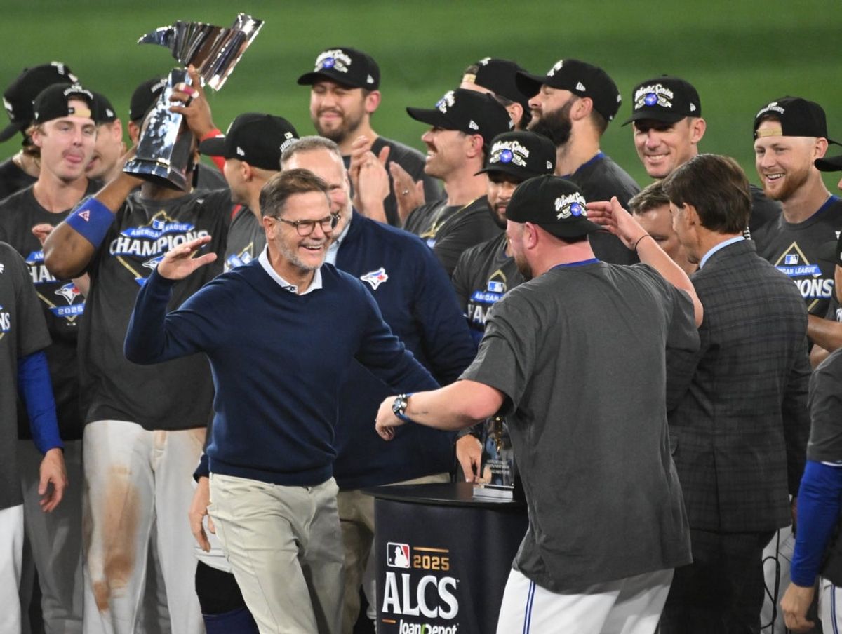Oct 20, 2025; Toronto, Ontario, CAN; Toronto Blue Jays general manager Ross Atkins celebrates with manager John Schneider (14) after winning game seven of the ALCS round for the 2025 MLB playoffs against the Seattle Mariners at Rogers Centre. Mandatory Credit: Dan Hamilton-Imagn Images