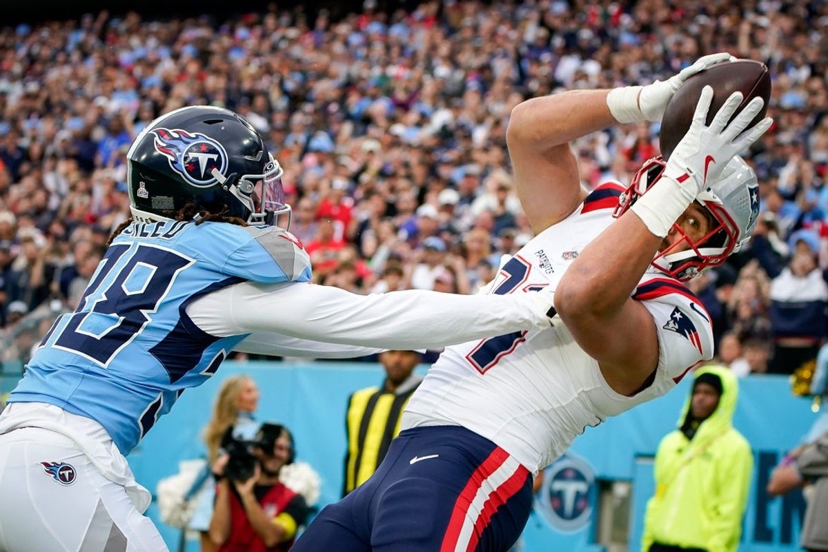 New England Patriots tight end Austin Hooper (81) catches a touchdown pass over Tennessee Titans cornerback L'Jarius Sneed (38) during the second quarter at Nissan Stadium in Nashville, Tenn., Sunday, Oct. 19, 2025.