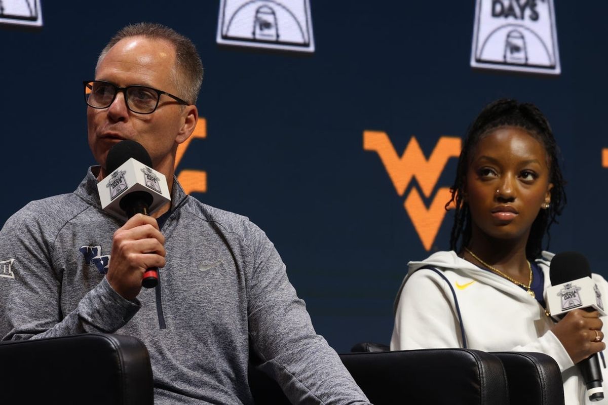 Oct 21, 2025; Kansas City, MO, USA; West Virginia head coach Mark Kellogg (left) and Jordan Harrison speak to media during Big 12 Womenís Basketball Media Day at T-Mobile Center. Mandatory Credit: Sophia Scheller-Imagn Images