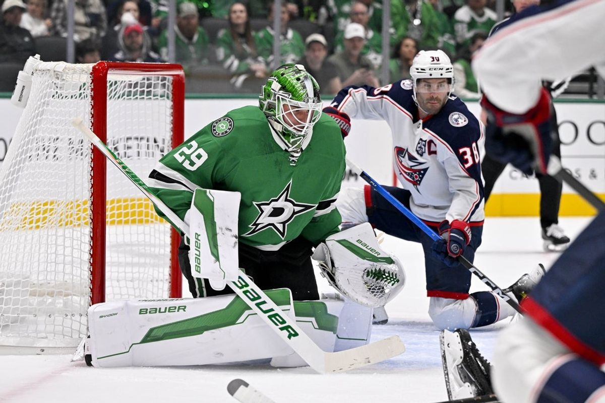 Oct 21, 2025; Dallas, Texas, USA; Columbus Blue Jackets center Boone Jenner (38) scores a power play goal against Dallas Stars goaltender Jake Oettinger (29) during the first period at the American Airlines Center. Mandatory Credit: Jerome Miron-Imagn Images