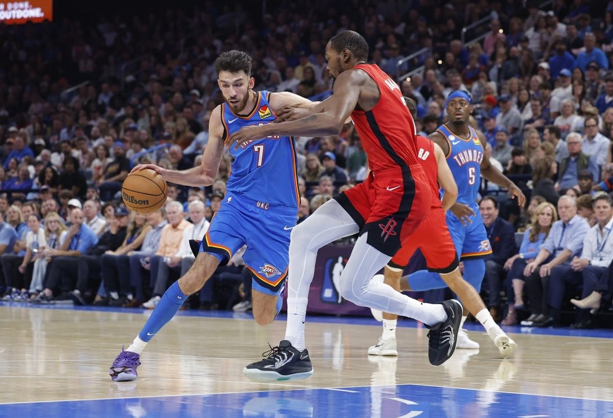 Oct 21, 2025; Oklahoma City, Oklahoma, USA; Oklahoma City Thunder center Chet Holmgren (7) moves the ball down the court as Houston Rockets forward Kevin Durant (7) defends during the first half at Paycom Center. Mandatory Credit: Alonzo Adams-Imagn Images