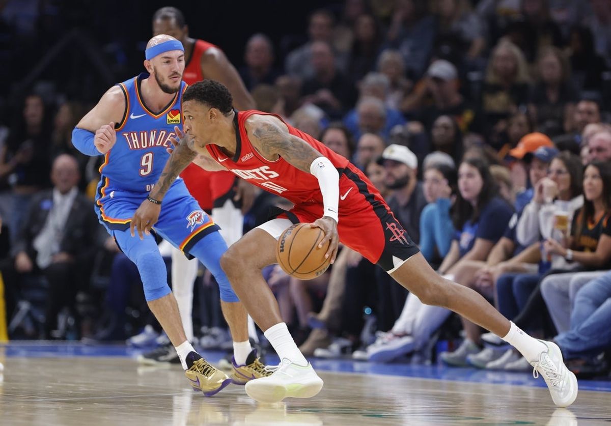 Oct 21, 2025; Oklahoma City, Oklahoma, USA; Houston Rockets forward Jabari Smith Jr. (10) drives past Oklahoma City Thunder guard Alex Caruso (9) during the first half at Paycom Center. Mandatory Credit: Alonzo Adams-Imagn Images