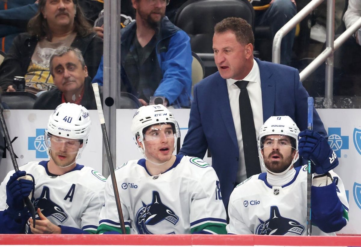 Oct 21, 2025; Pittsburgh, Pennsylvania, USA;  Vancouver Canucks head coach Adam Foote (right rear) gestures on the bench against the Pittsburgh Penguins during the third period at PPG Paints Arena. Mandatory Credit: Charles LeClaire-Imagn Images