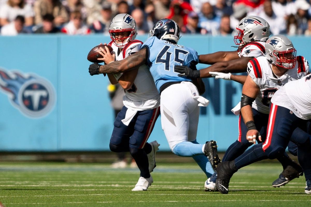 Oct 19, 2025; Nashville, Tennessee, USA;  Tennessee Titans outside linebacker Dre'Mont Jones (45) sacks New England Patriots quarterback Drake Maye (10) during the second half at Nissan Stadium. Mandatory Credit: Steve Roberts-Imagn Images