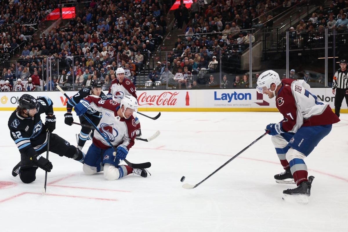 Oct 21, 2025; Salt Lake City, Utah, USA; Utah Mammoth center Kevin Stenlund (82) battles for the puck with Colorado Avalanche center Jack Drury (18) and defenseman Devon Toews (7) during the first period at Delta Center. Mandatory Credit: Rob Gray-Imagn Images