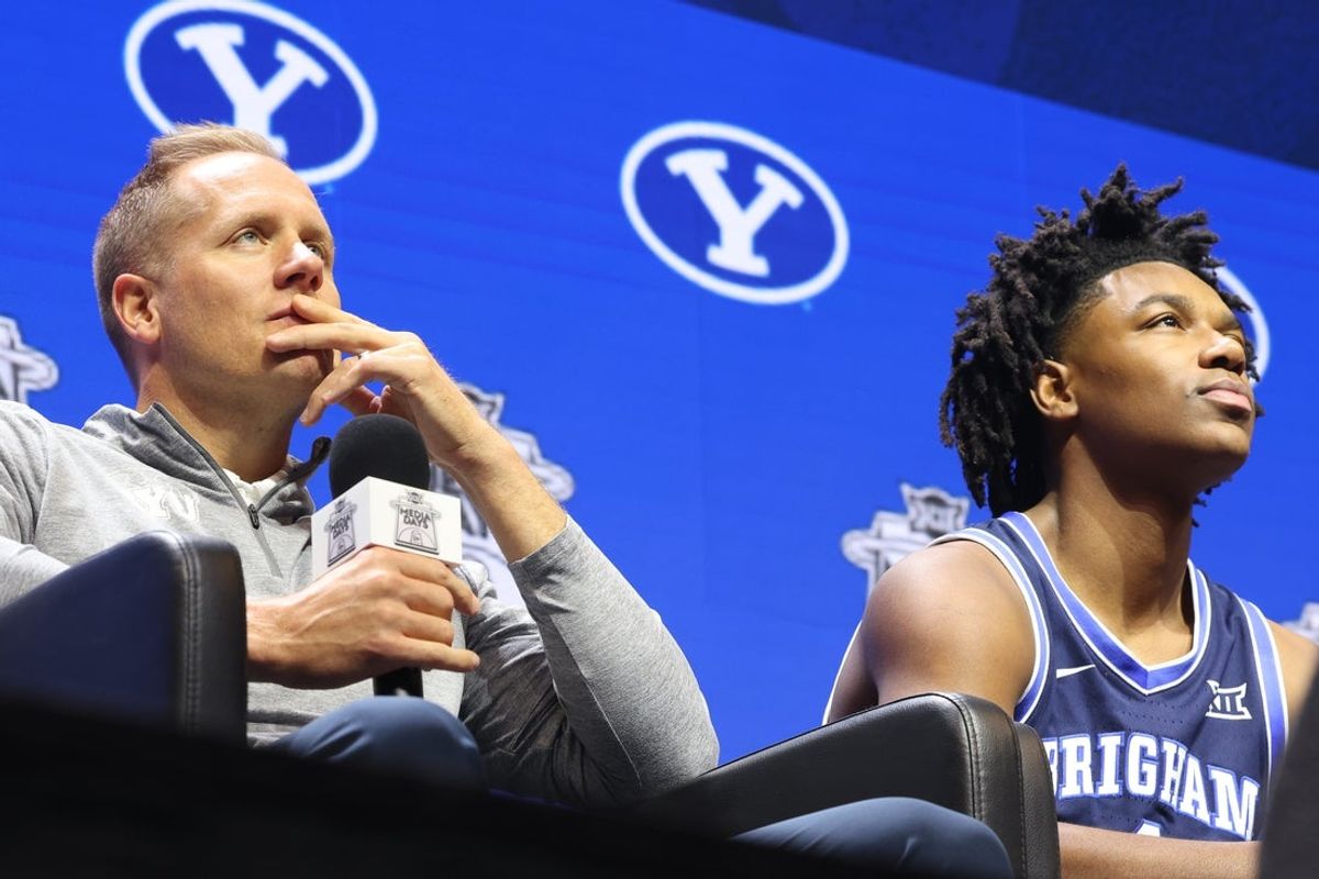 Oct 22, 2025; Kansas City, MO, USA; BYU head coach Kevin Young (left) and Robert Wright III (right) speak to media during Big 12 Menís Basketball media day at T-Mobile Center. Mandatory Credit: Sophia Scheller-Imagn Images